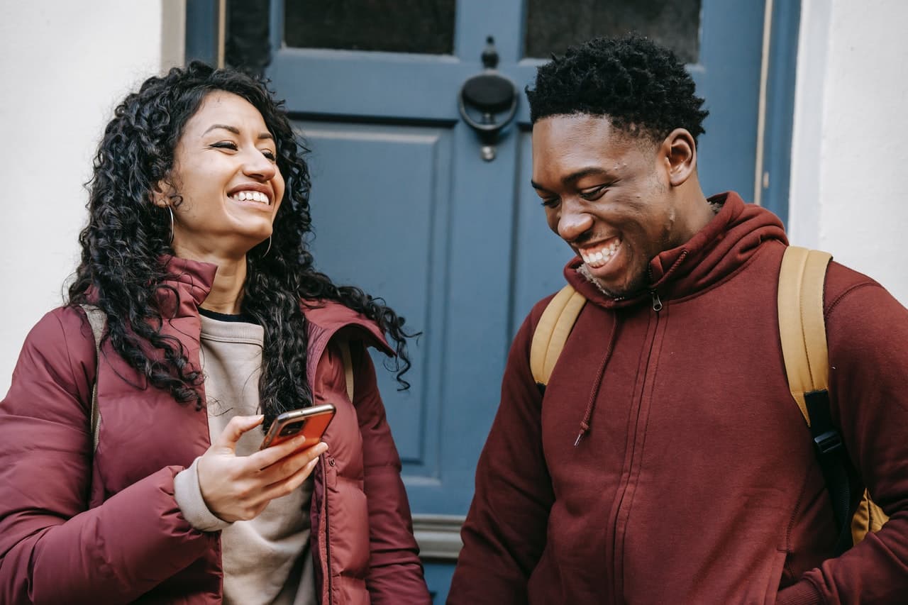 Two ACCA candidates reviewing a class on a phone.